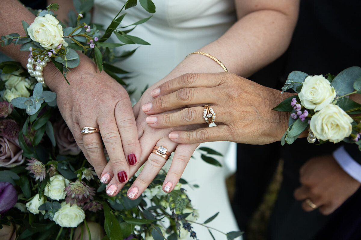 generational wedding ring photo with wrist corsages in white and green flowers
