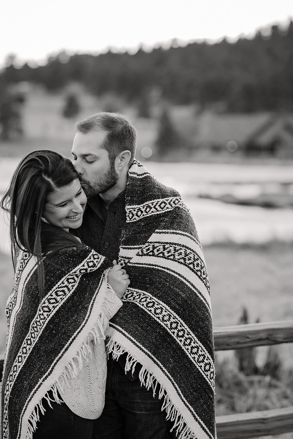 engaged couple covered in blanket