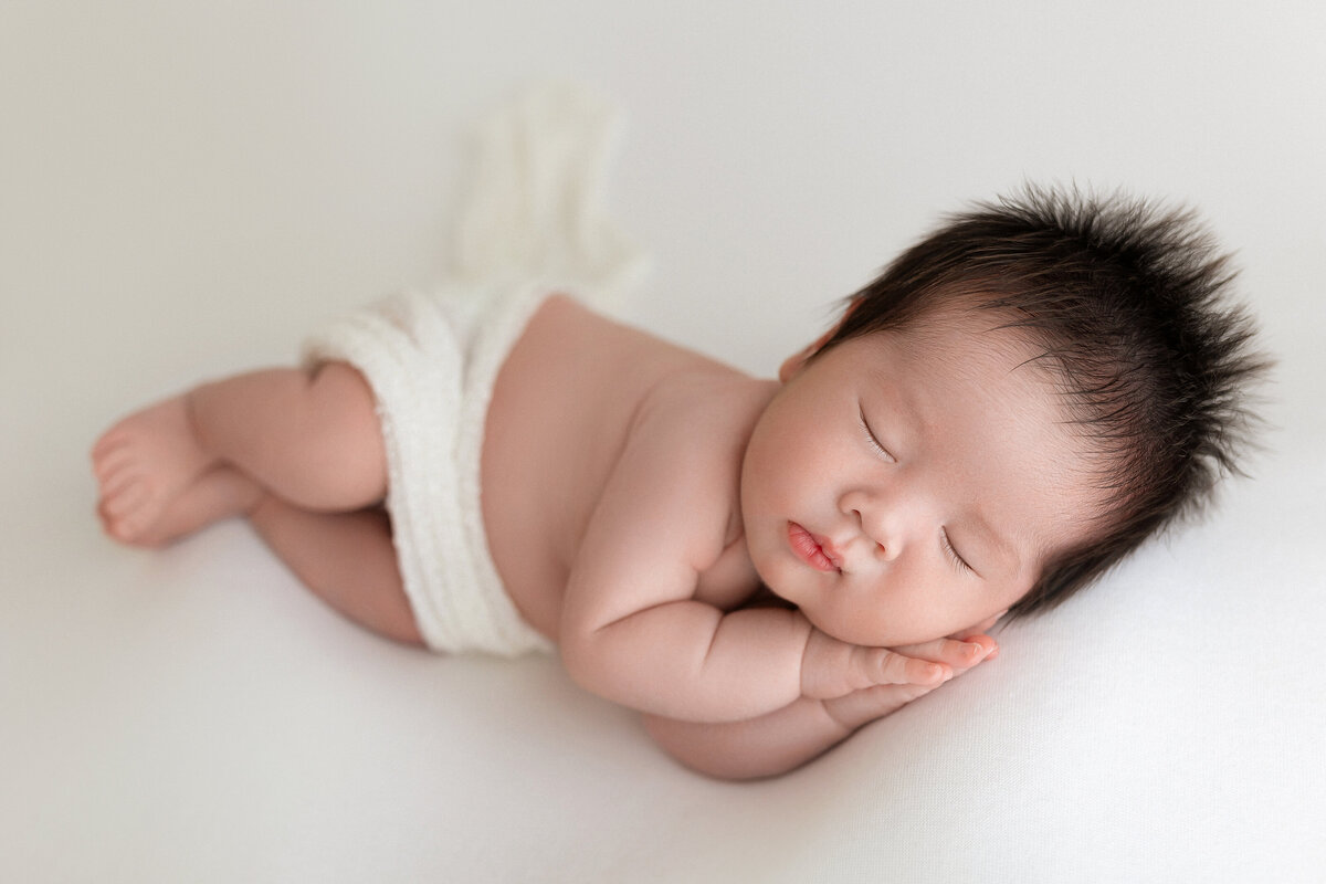 baby boy with a lot of hair sleeping