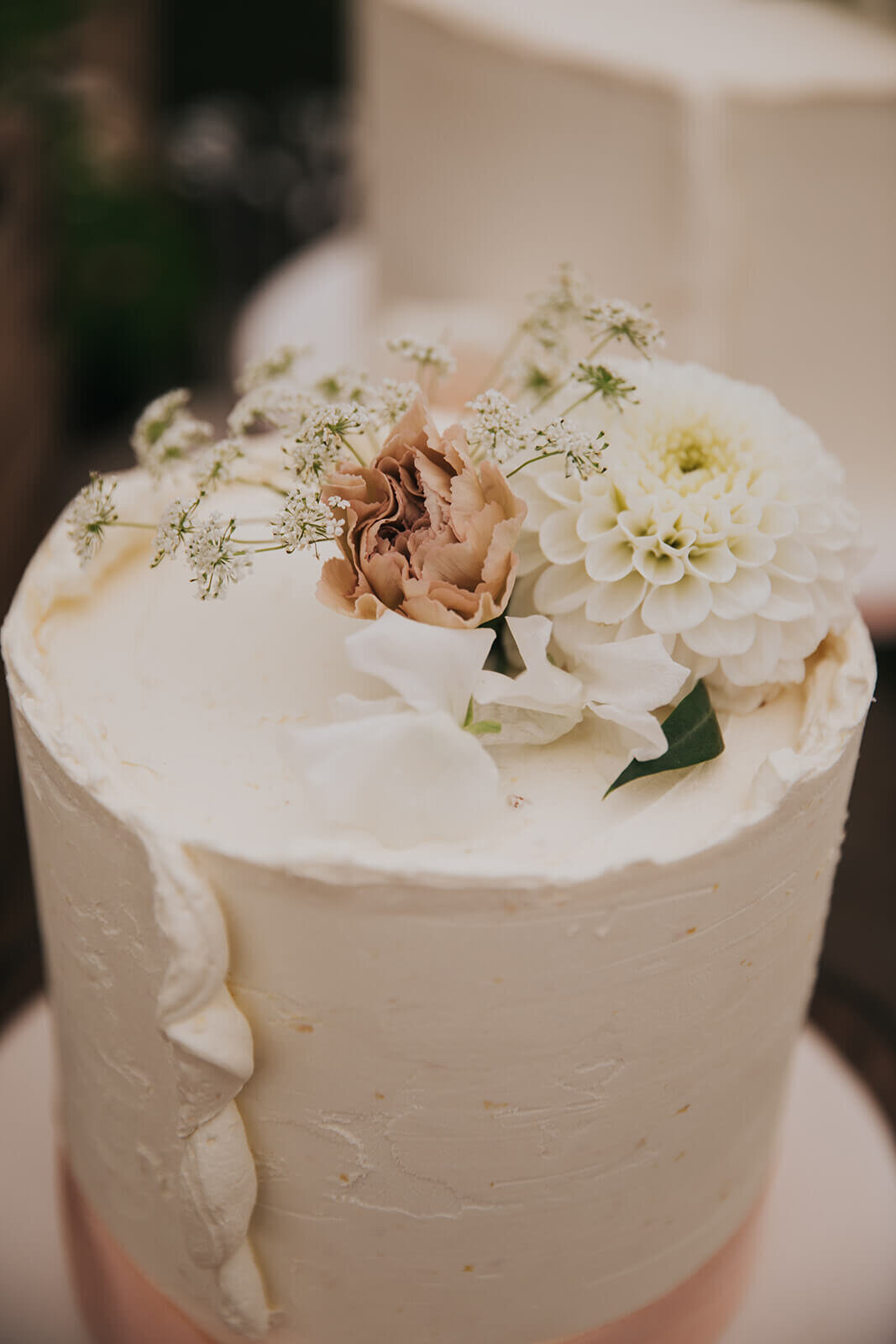 The top of a wedding cake showing a floral top