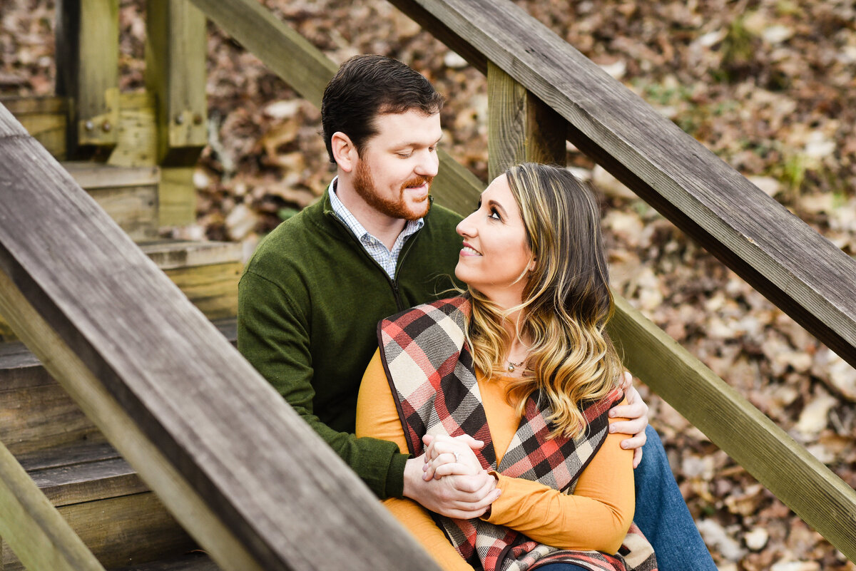 Beautiful Mississippi Engagement Photography: couple sits on wooden staircase in fall clothing