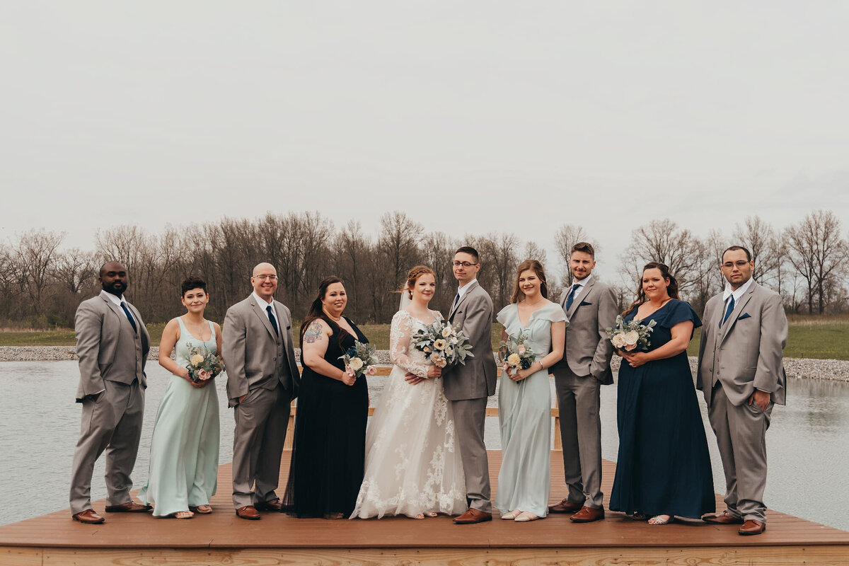 large bridal party near water