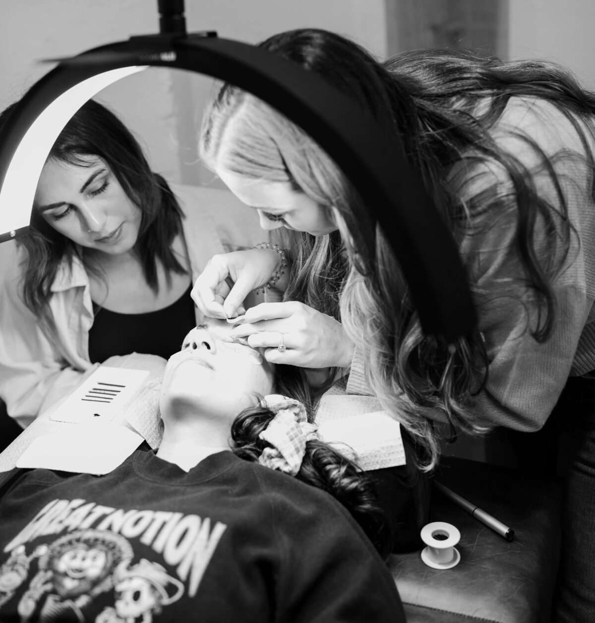 Owner of Milan Esthetics in Corvallis helps another artist learn how to apply lashes