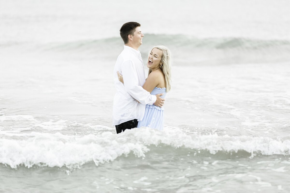 Young couple playing in the ocean