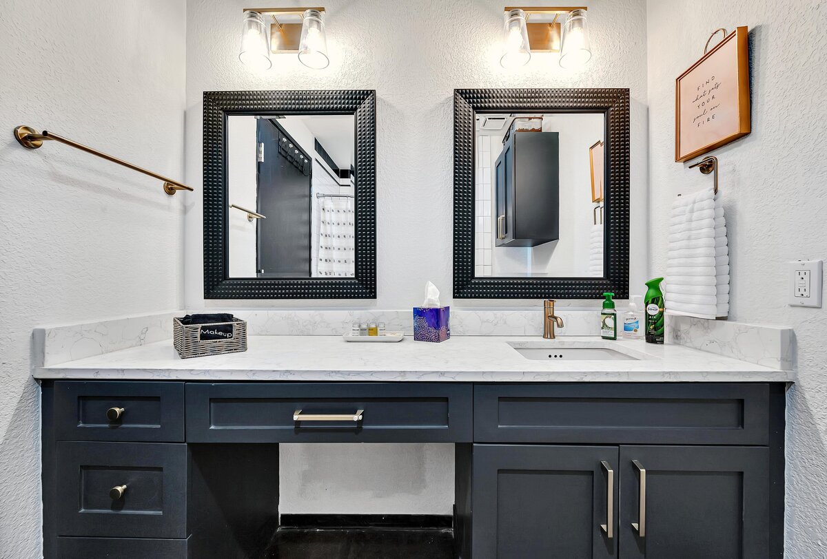 Bathroom vanity with dual sinks in this two-bedroom, two-bathroom vacation rental condo in the historic Behrens building in the heart of the Magnolia Silo District in downtown Waco, TX.