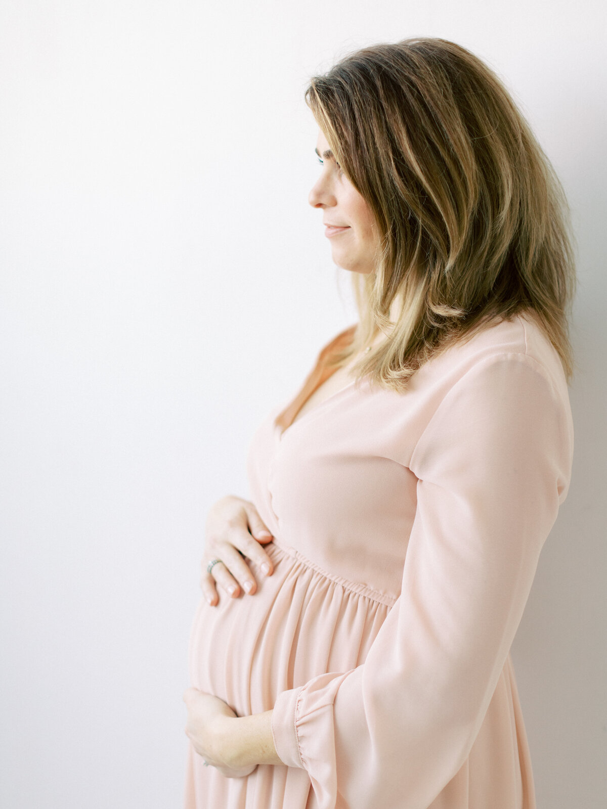 maternity image of mom in pink dress taken by madison wi photographer Talia Laird Photography