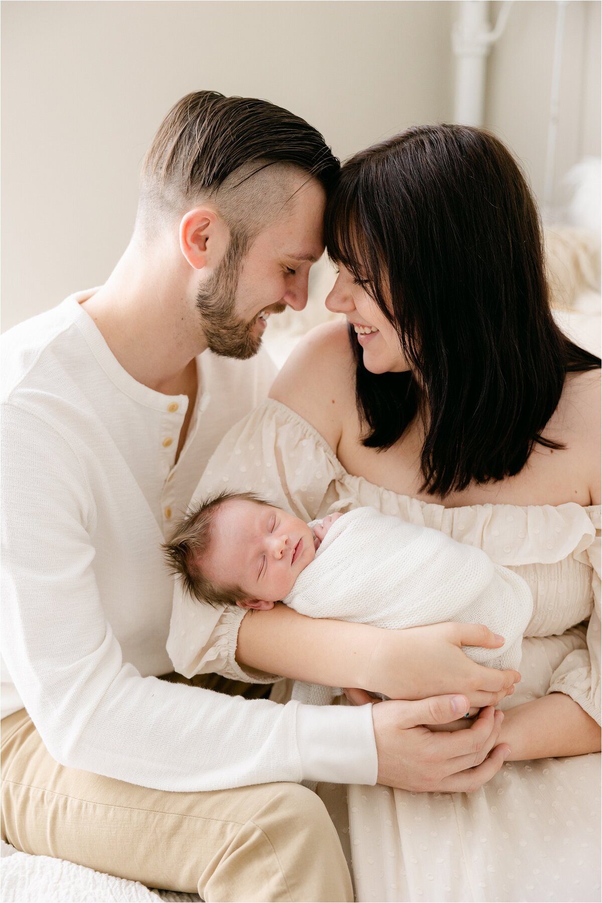 couple holding their baby boy during studio newborn session