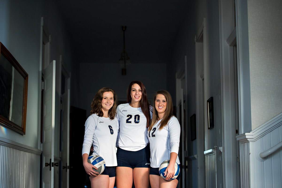 College volley ball athletes pose.