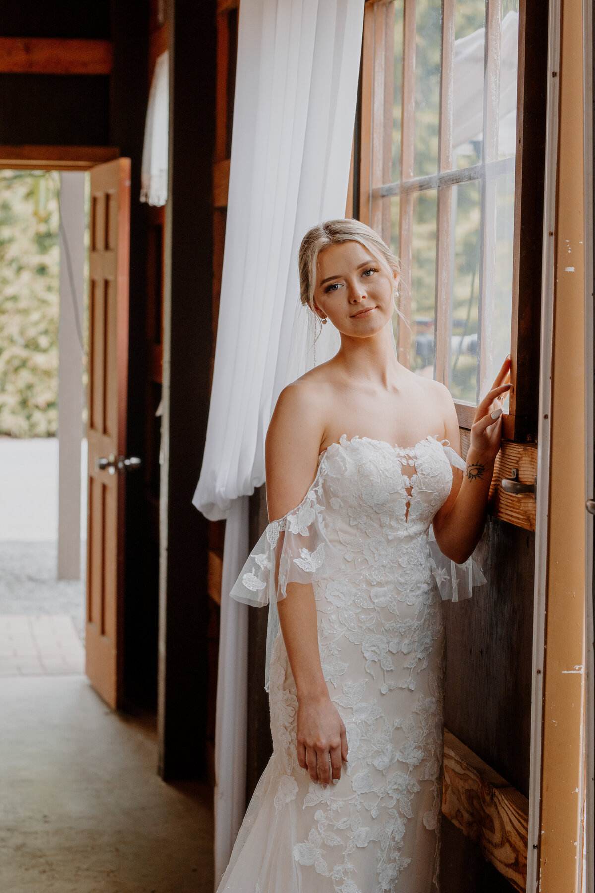Bride inside smiling next to window