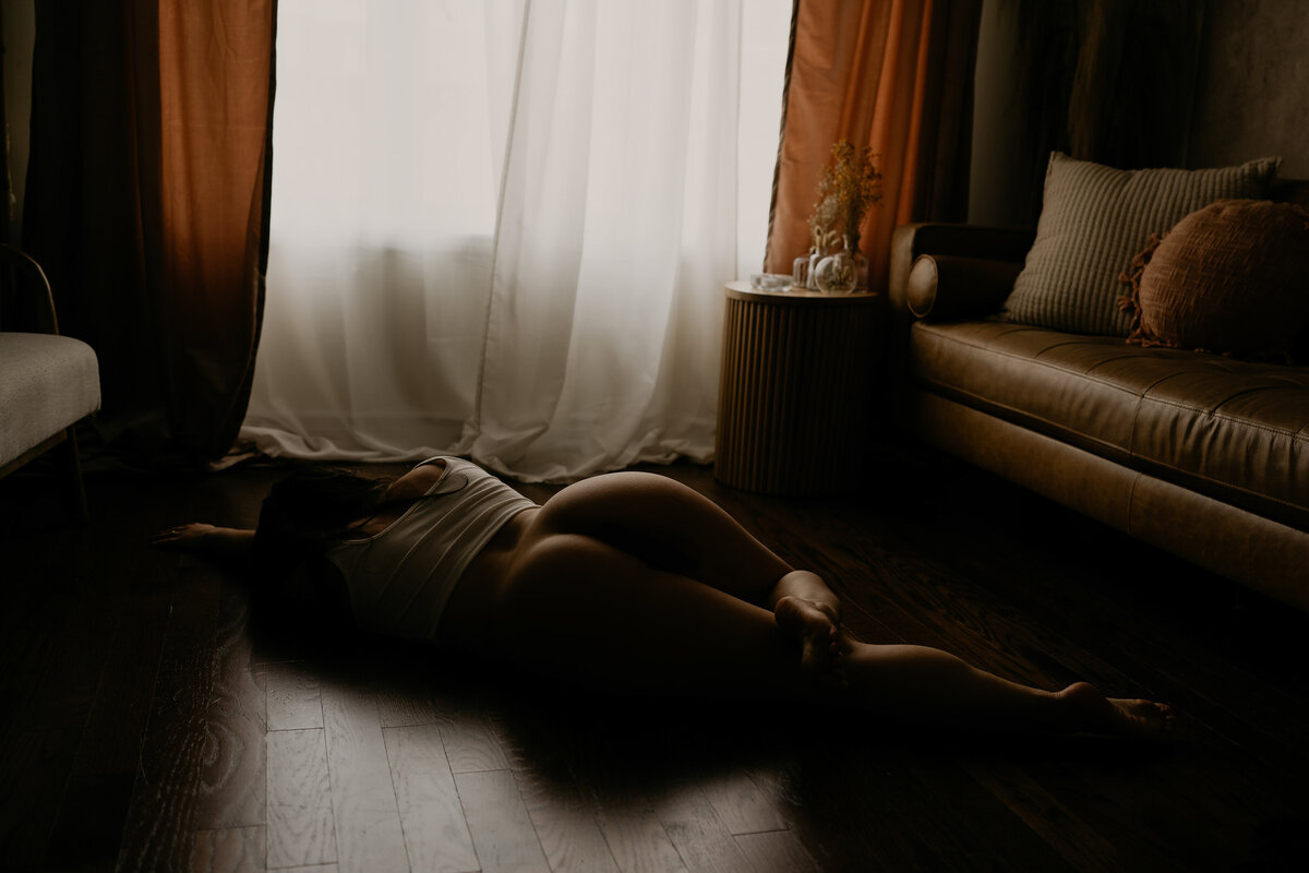 woman laying on the floor of a living room