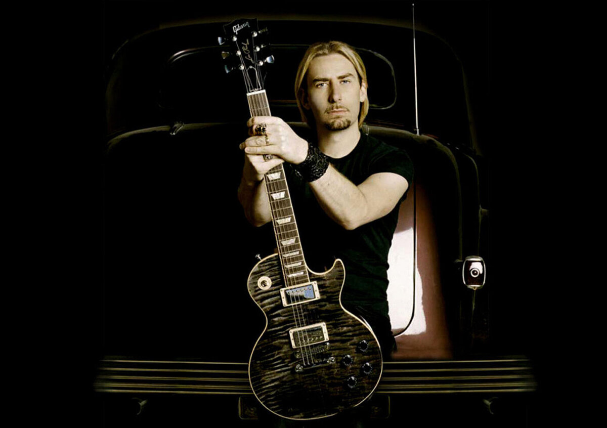 Chad Kroeger Musician Portrait sitting on the back of burgundy vintage car holding his Signature Black Water Gibson Les Paul Guitar standing up in his lap
