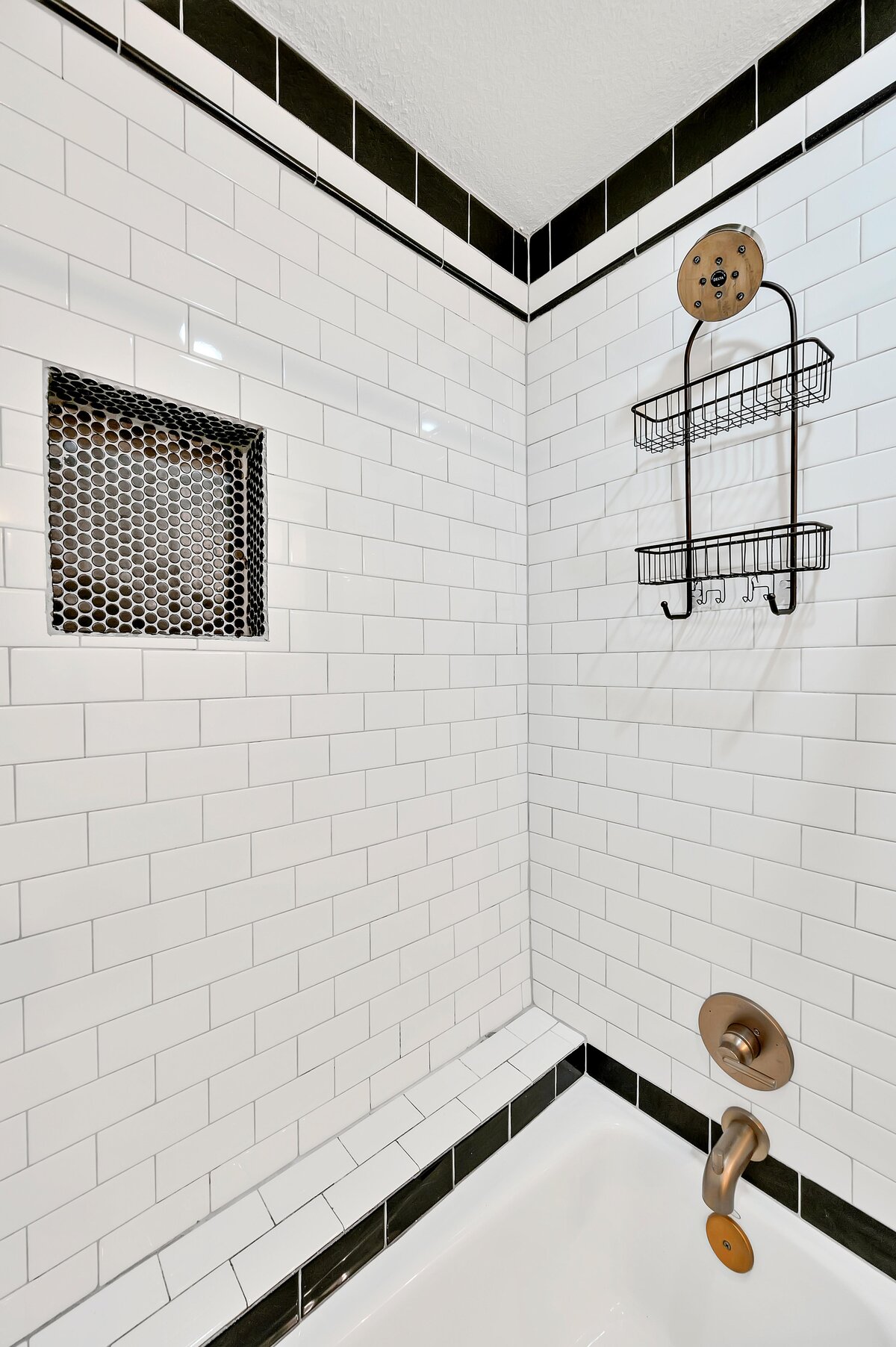 Tub/shower combo in the full bathroom of this two-bedroom, two-bathroom vacation rental condo in the historic Behrens building in the heart of the Magnolia Silo District in downtown Waco, TX.