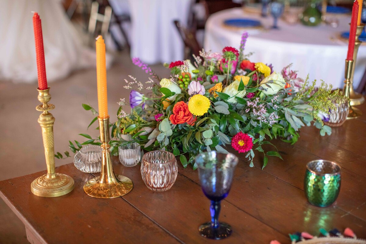vivid color wedding sweetheart table decor including beeswax candles in San Marcos Texas