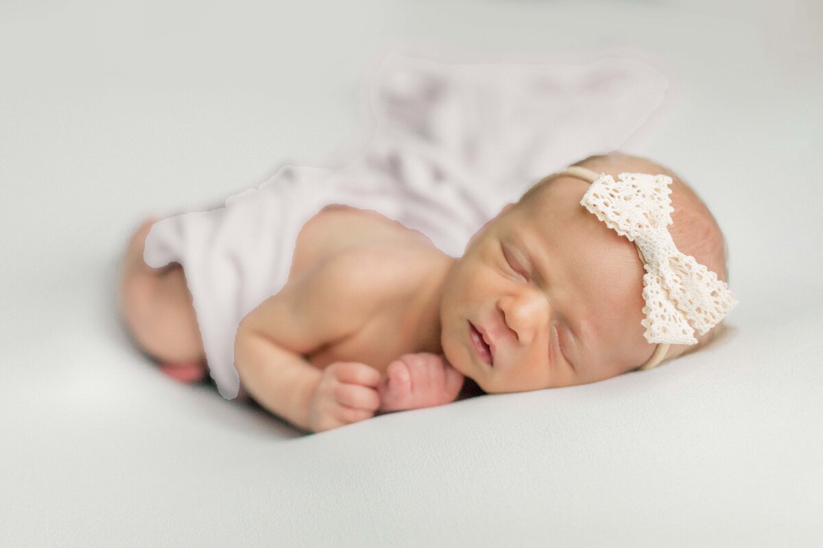 Baby posed on a light and airy backdrop for their lifestyle in-home newborn session in Cincinnati