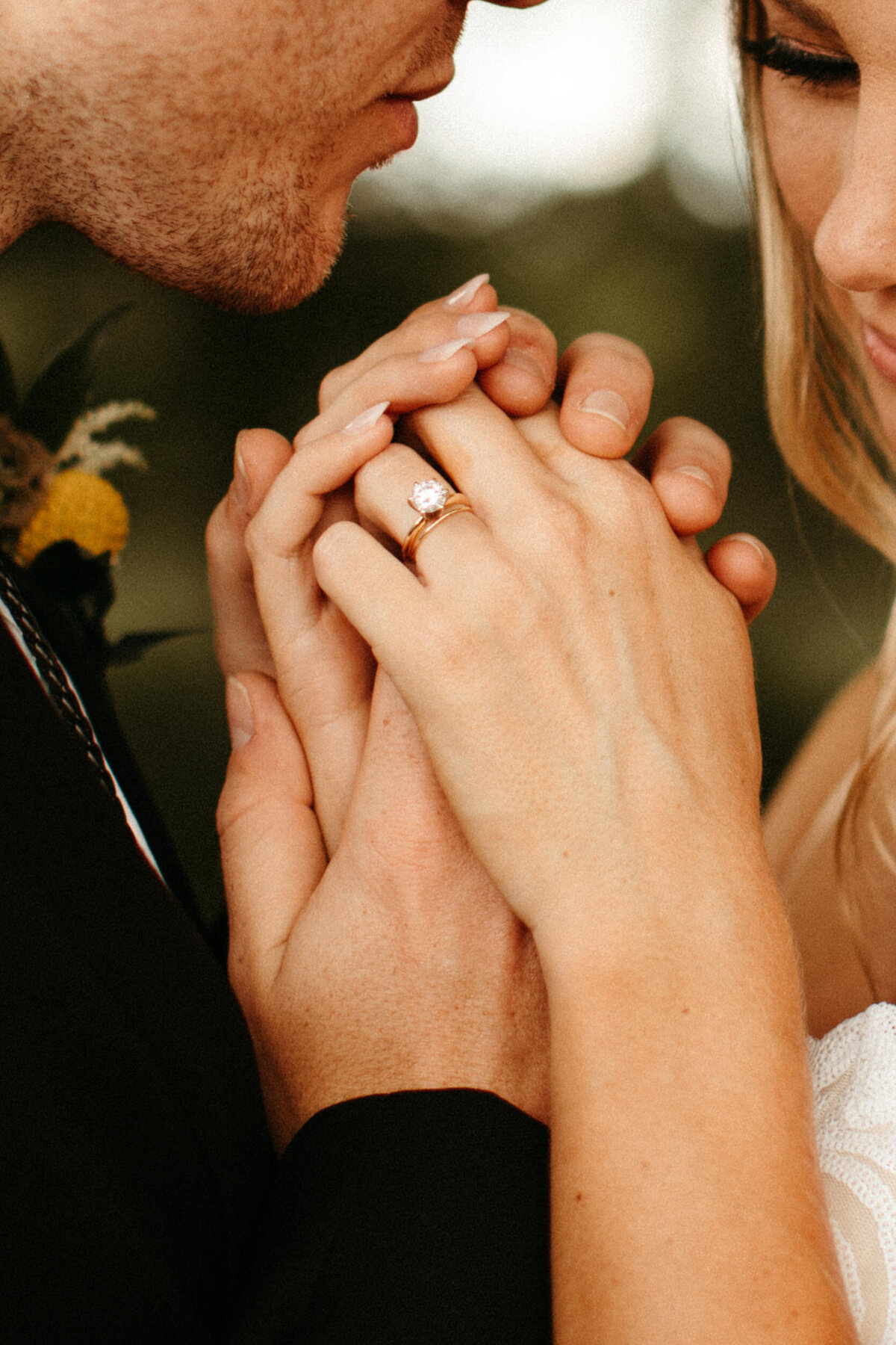 Close up view of a bride and groom holding hands on their wedding day