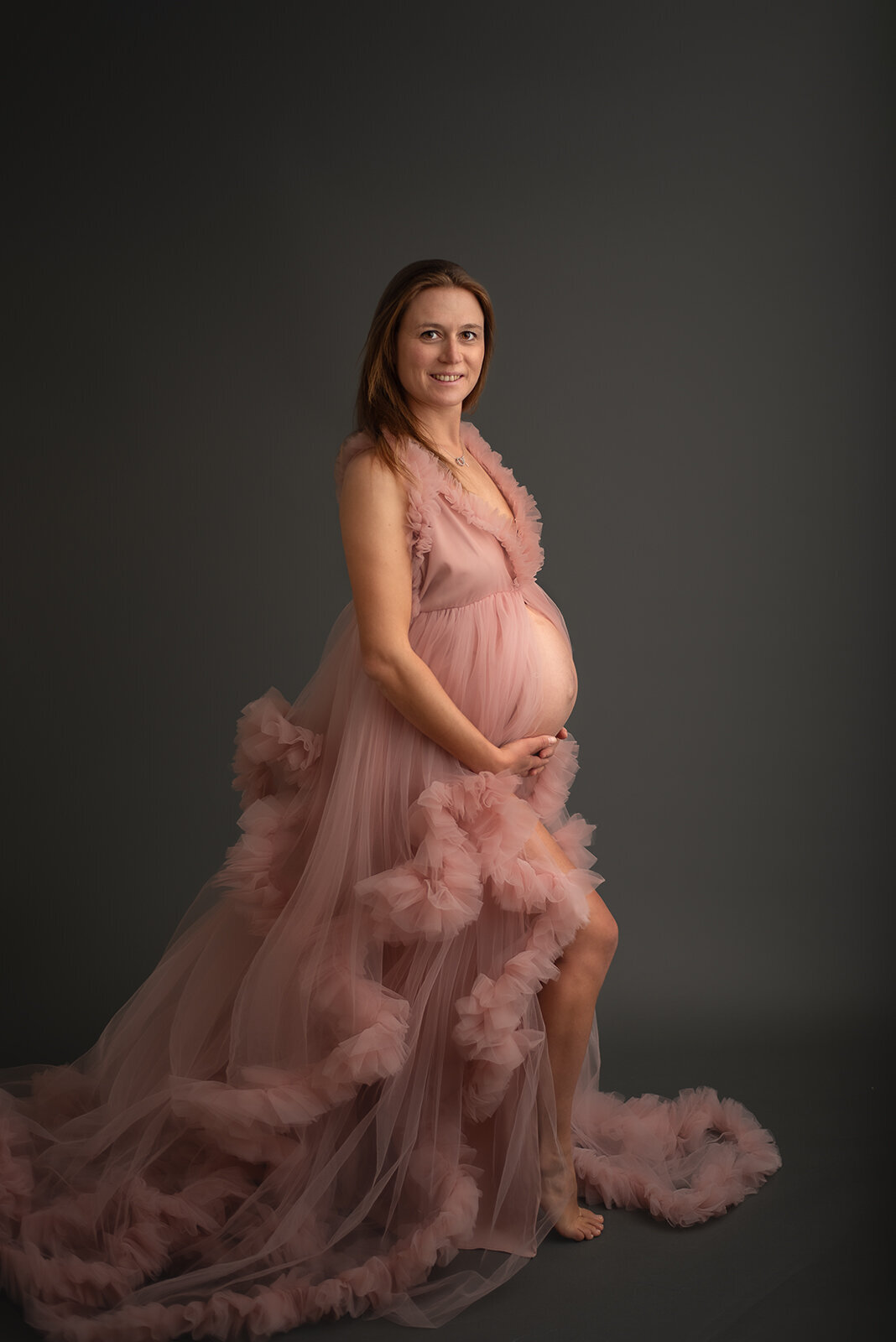 pregnant woman in tulle pink gown