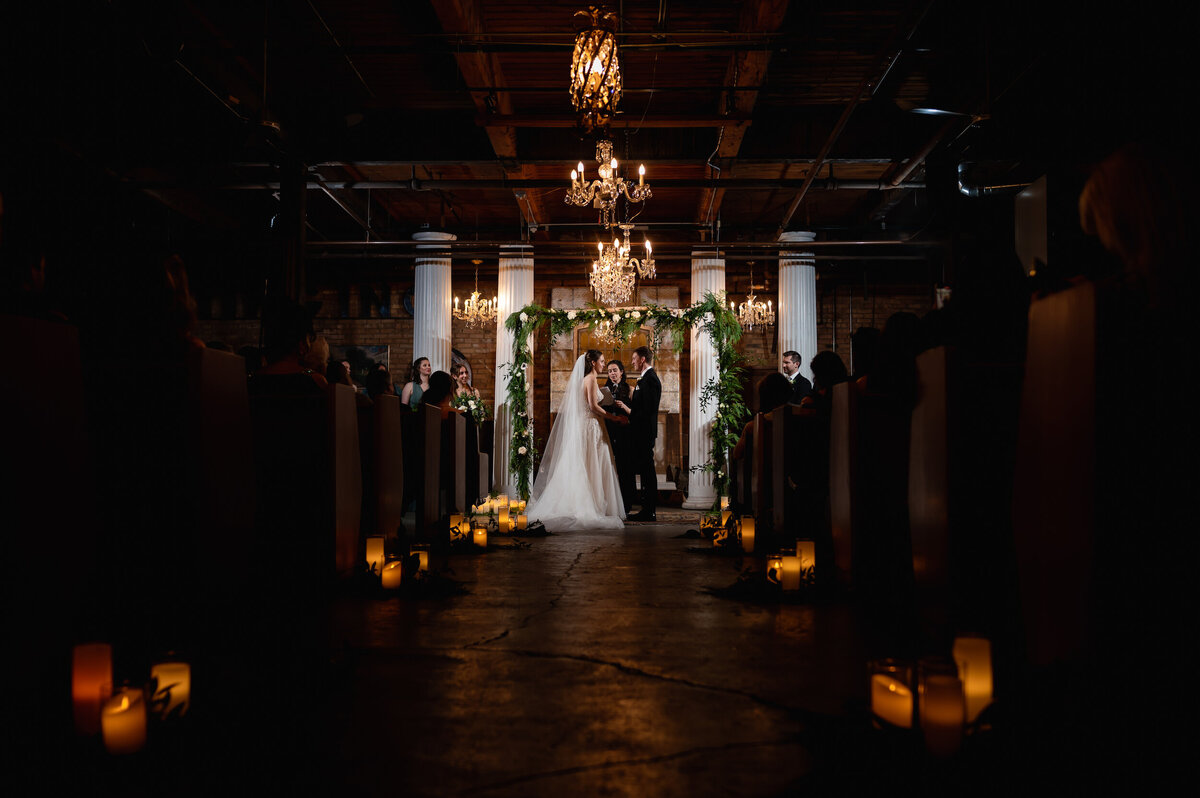 Candlelit wedding ceremony at Salvage One in Chicago, Illinois