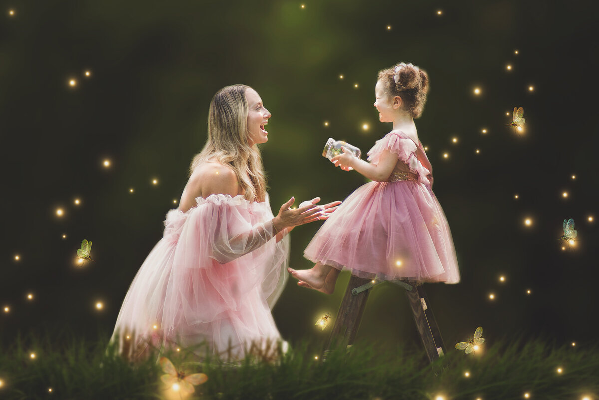 Mother wearing pink dress with daughter wearing pink dress during mommy and me photoshoot in Mount Juliet, Tennessee photography