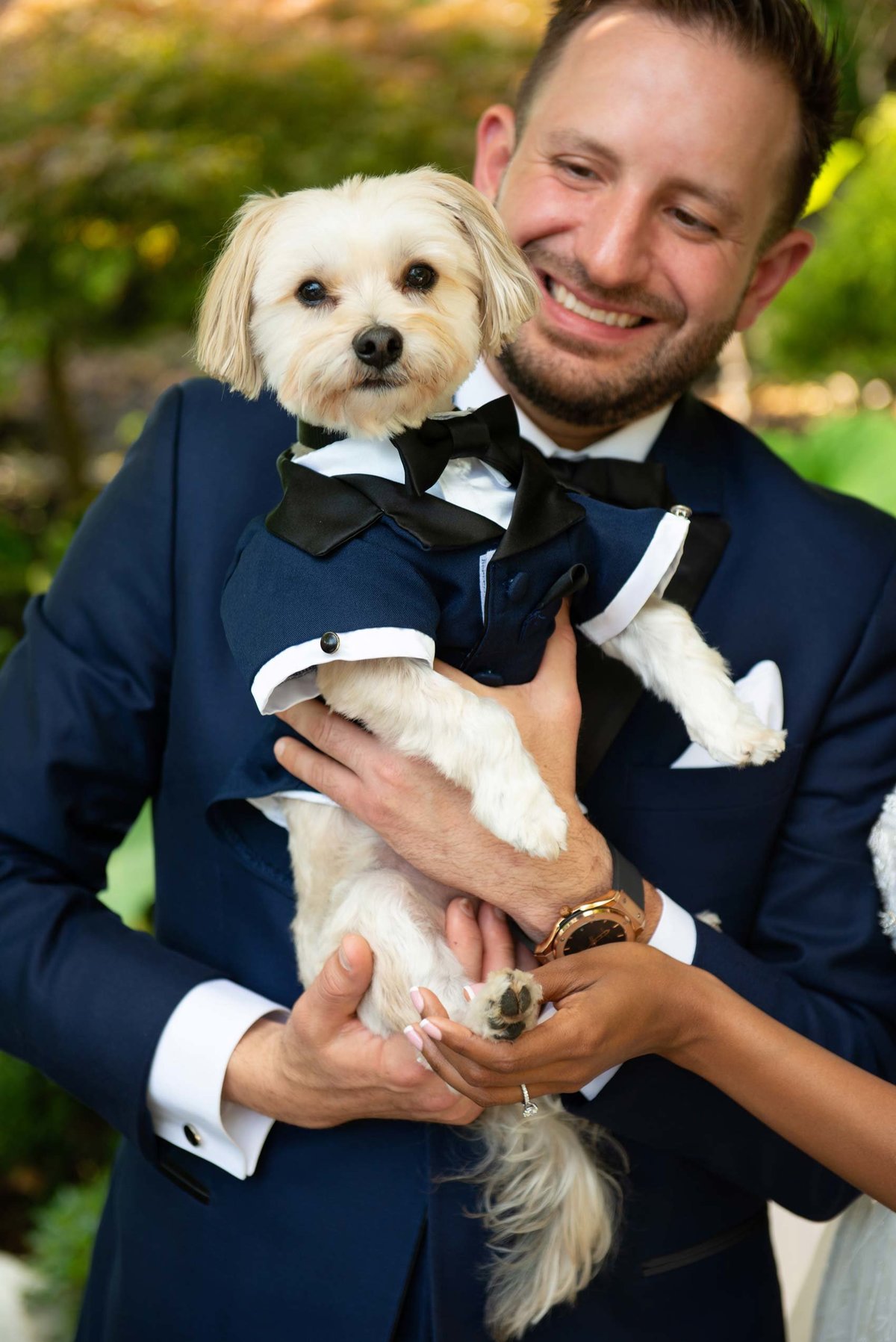 Groom holding dog at Fox Hollow