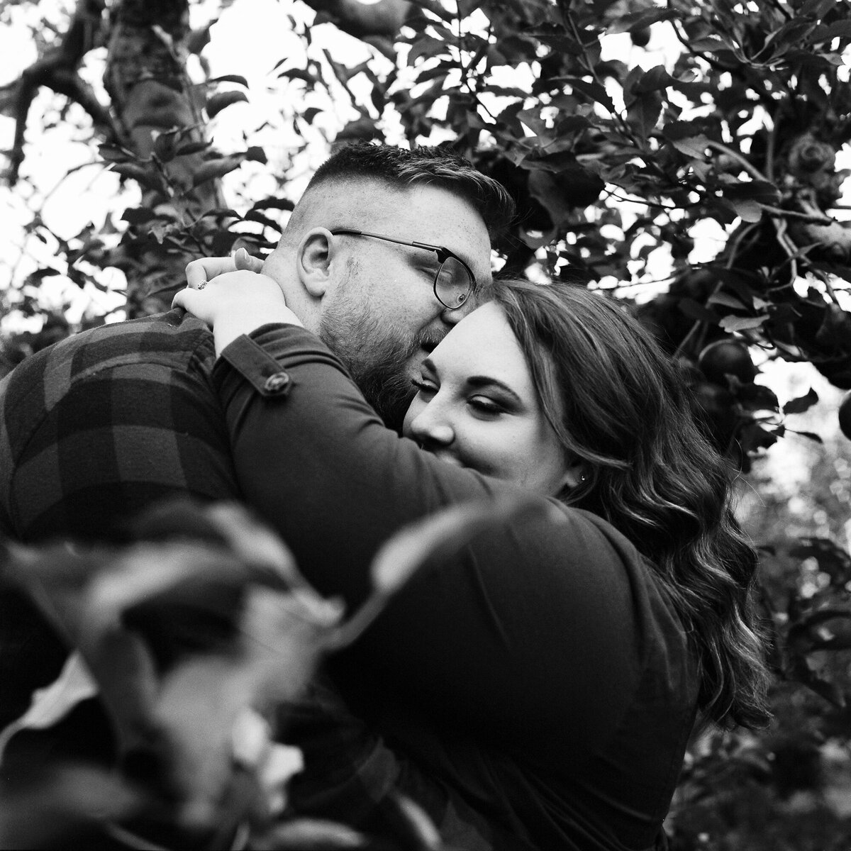 Couple snuggles under the apple trees at Lynds. Photo taken on Tri-X pushed one