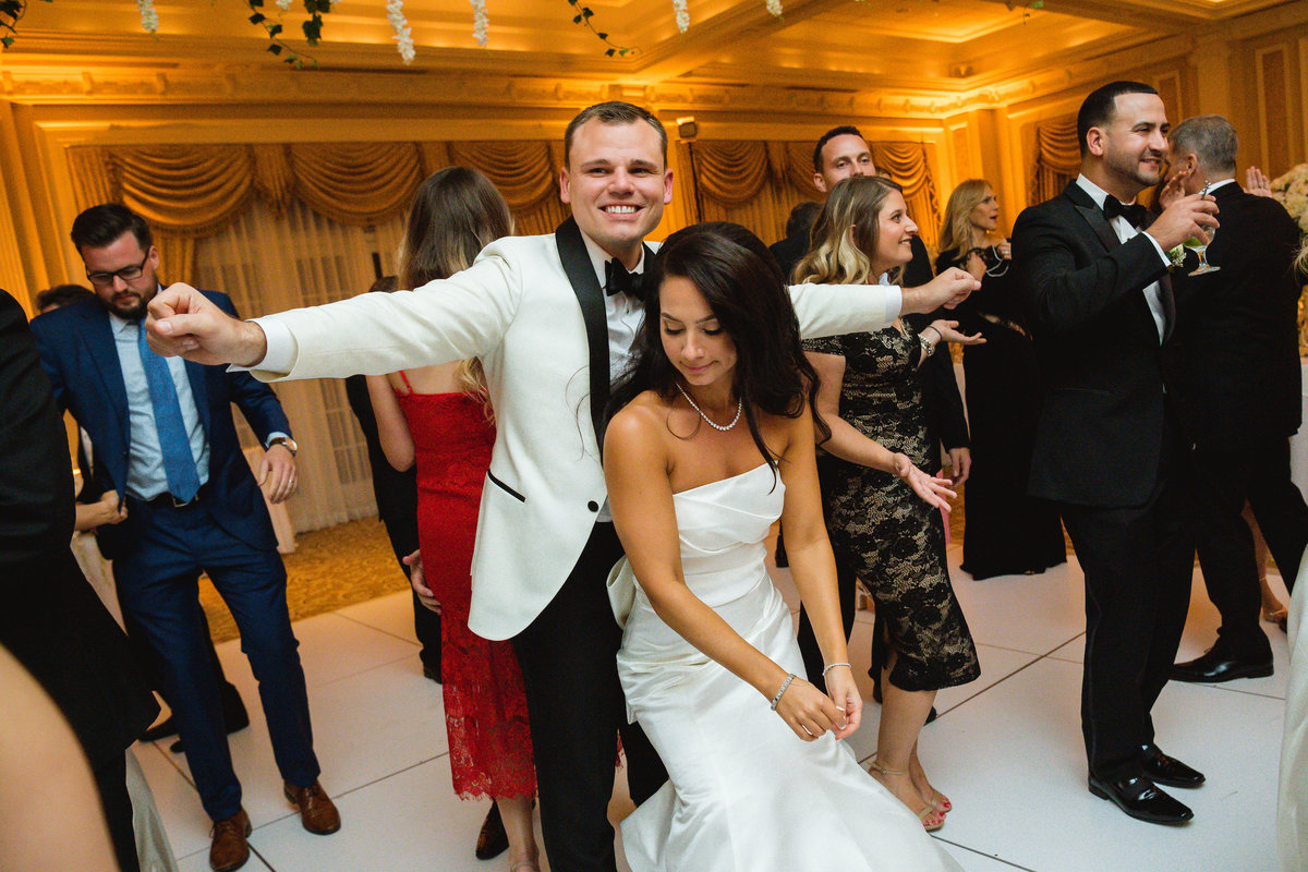 bride and groom dancing on the dance floor during wedding reception at The Muttontown Club