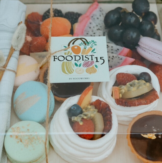 seasonally inspired french macarons, fresh fruit mini pavlova, dark chocolate-passionfruit caramel tartelette, dehydrated fruit garnish, created by Food Works Craft Catering, contemporary catering in Calgary, Alberta, featured on the Brontë Bride Vendor Guide.