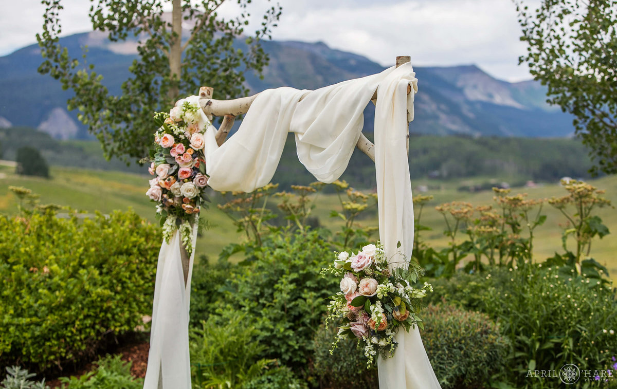 Lucky Penny Wedding Planner custom wood arch with floral design in Crested Butte Colorado