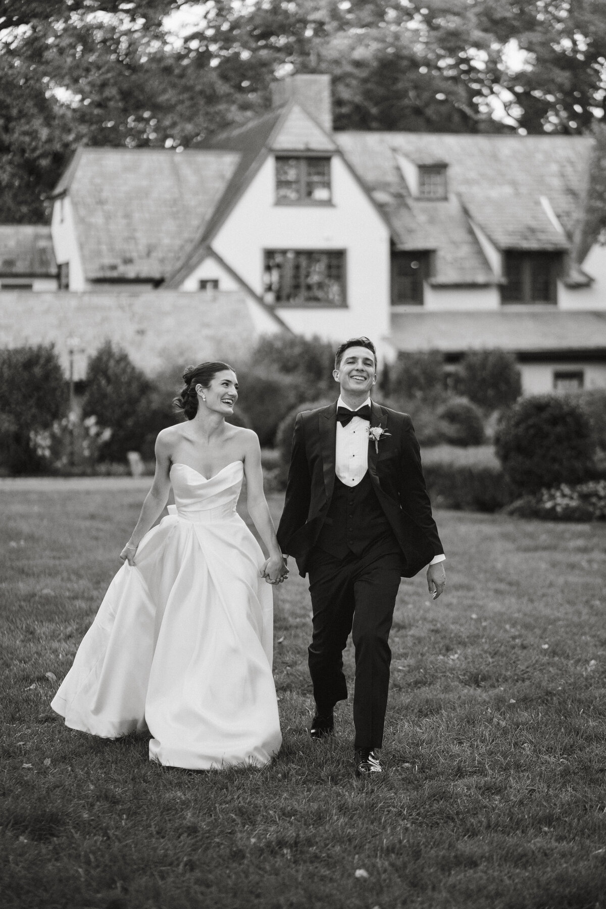 Bride and groom walking in front of a building