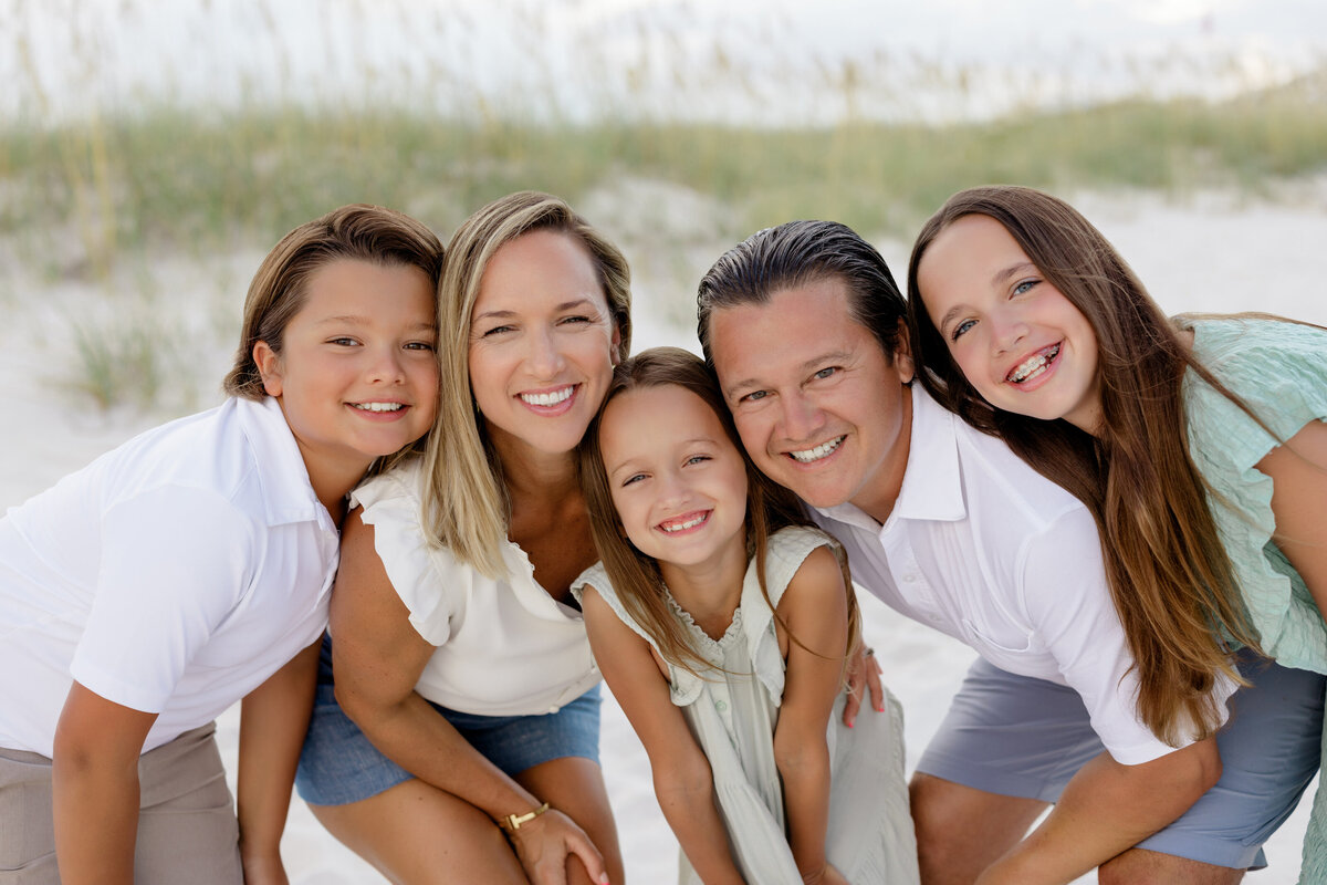 A family crouching down together smiling