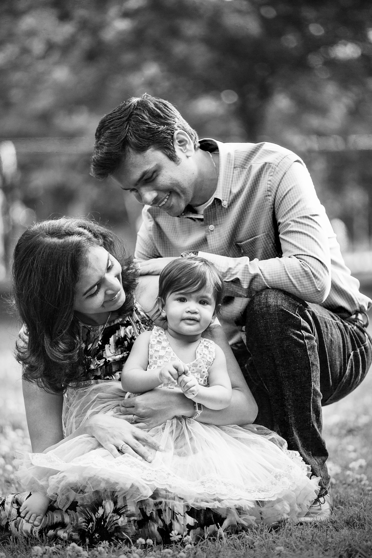 charlotte family photographer creates beautiful black and white portrait of mother and father with daughter on her one year birthday