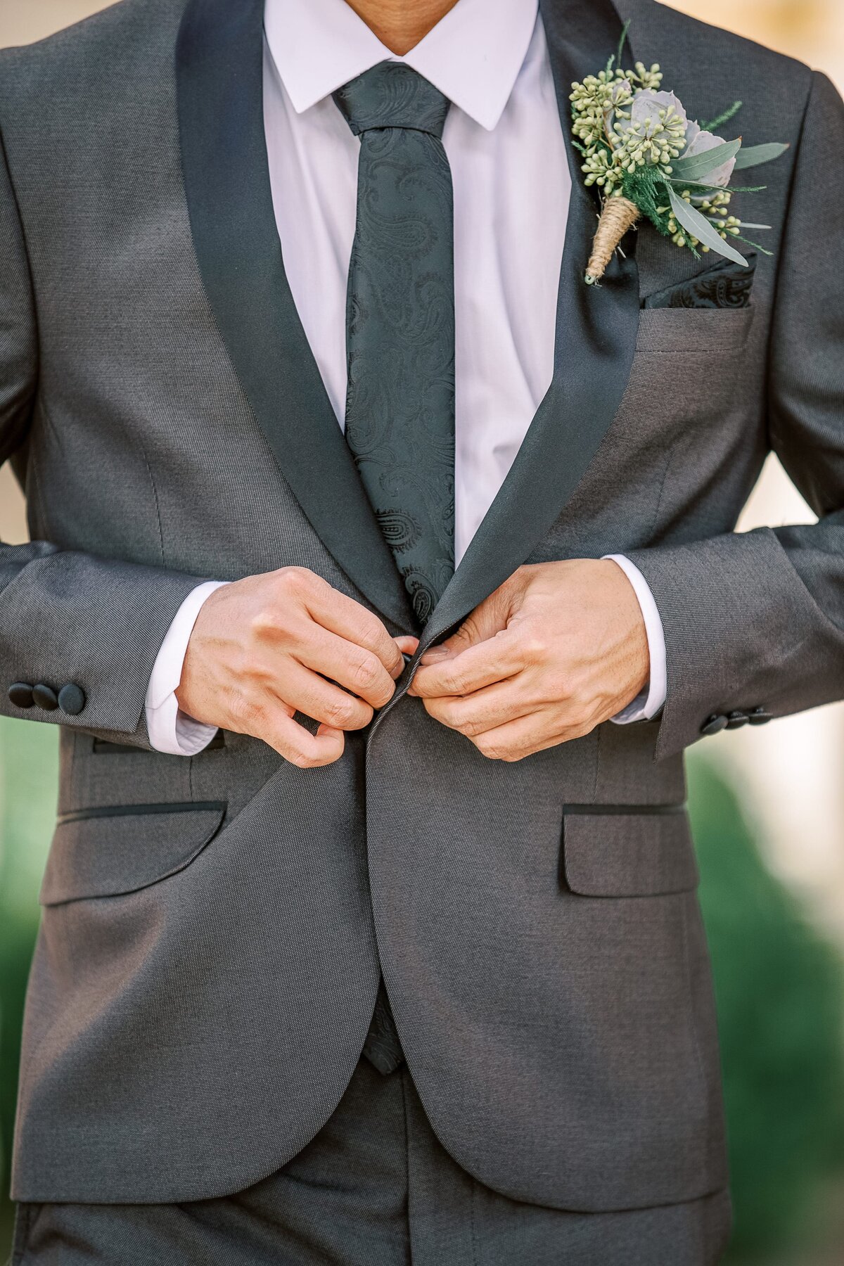 groom-buttoning-suit-coat