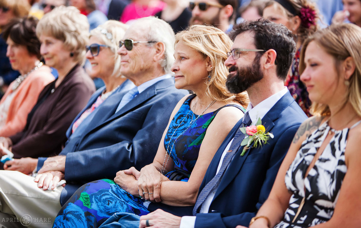 Wedding guests look on at wedding ceremony emotionally at B Lazy 2 Ranch in Fraser Colorado