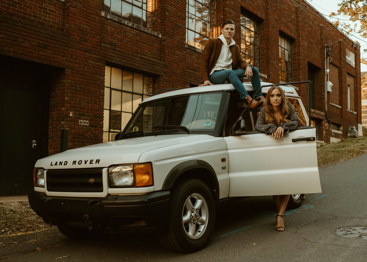 couple uses car for editorial photos during their engagement session in charlotte, nc