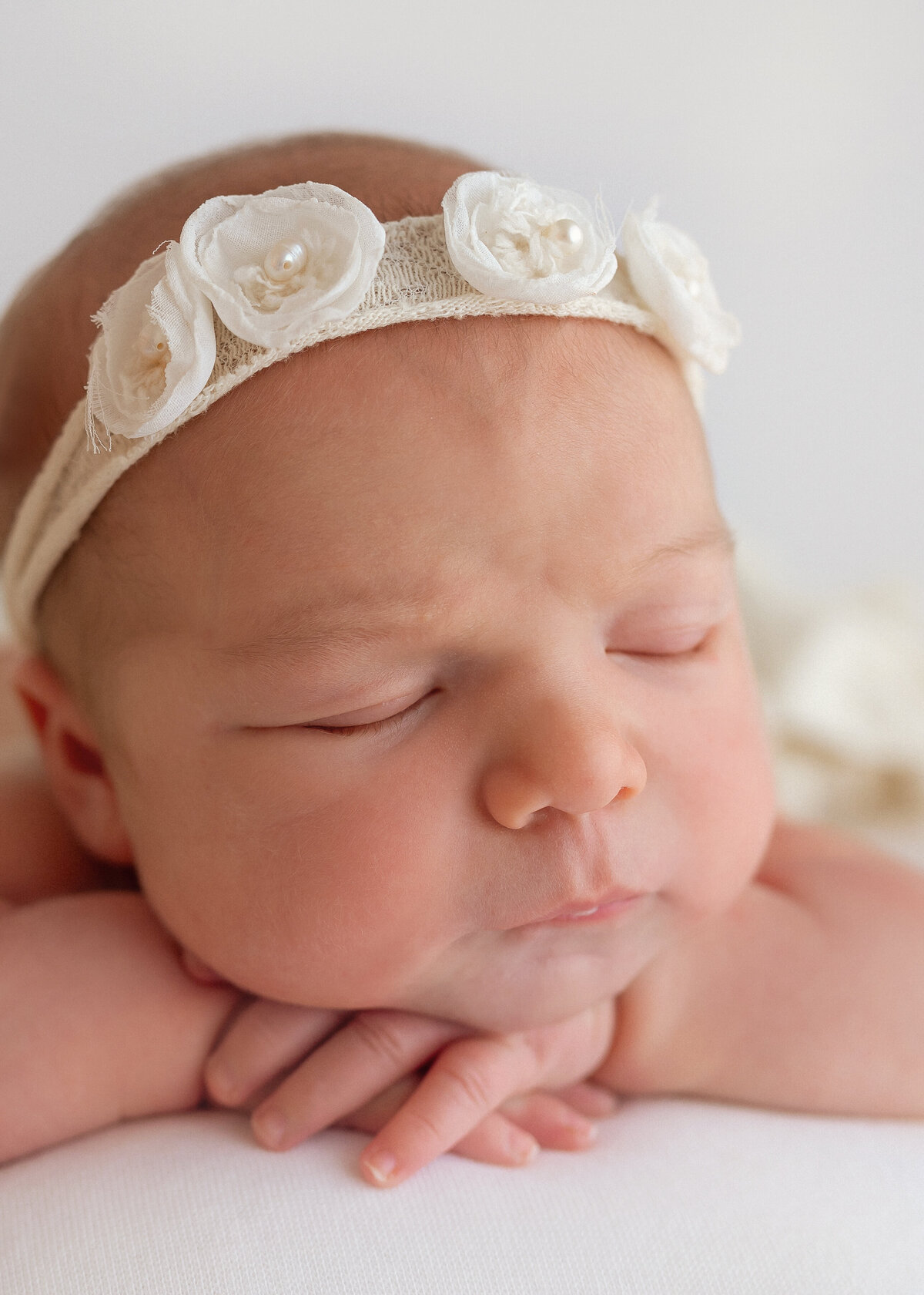 baby with chin on hands