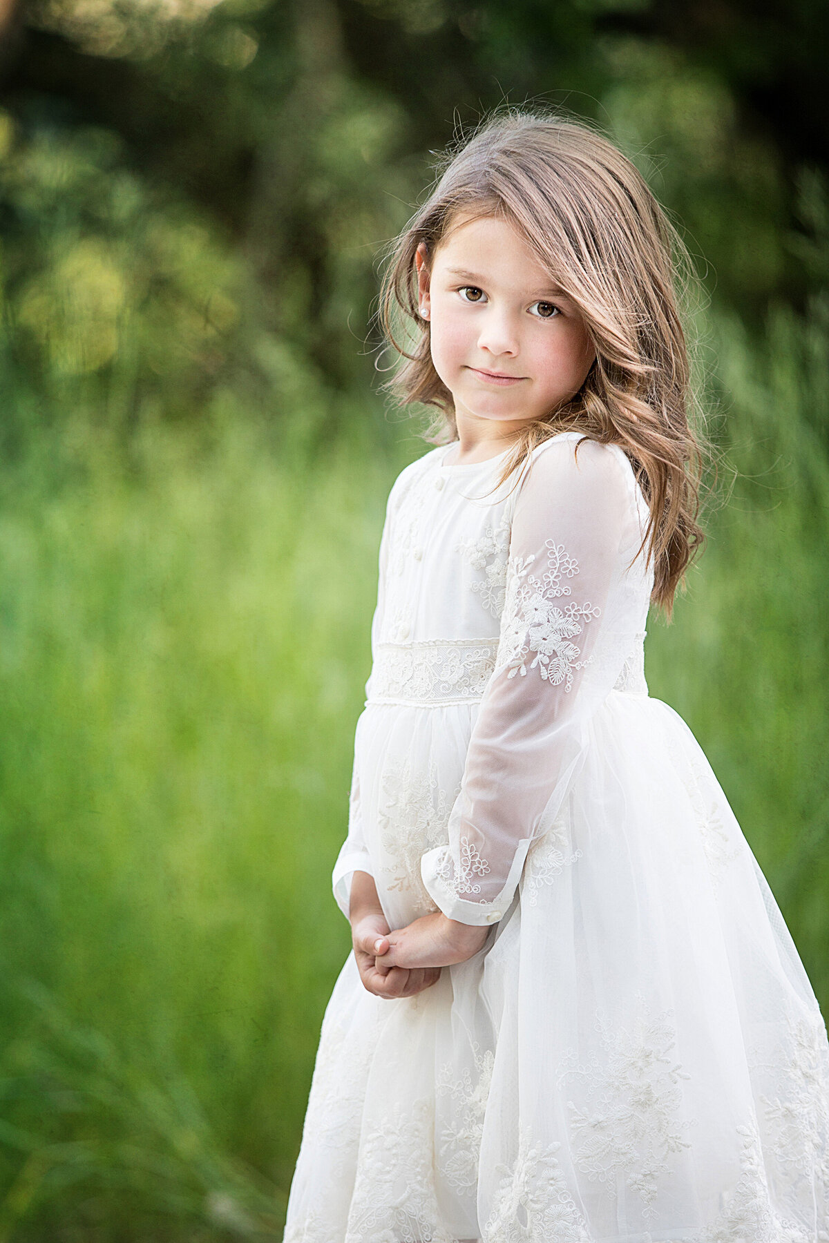 Brown haired girl in white dress, photographed at river front park in billings montana.