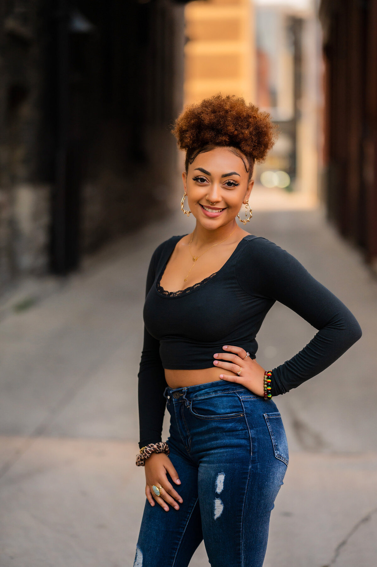 A Catholic Memorial High School senior poses in a bright alleyway for her portrait.
