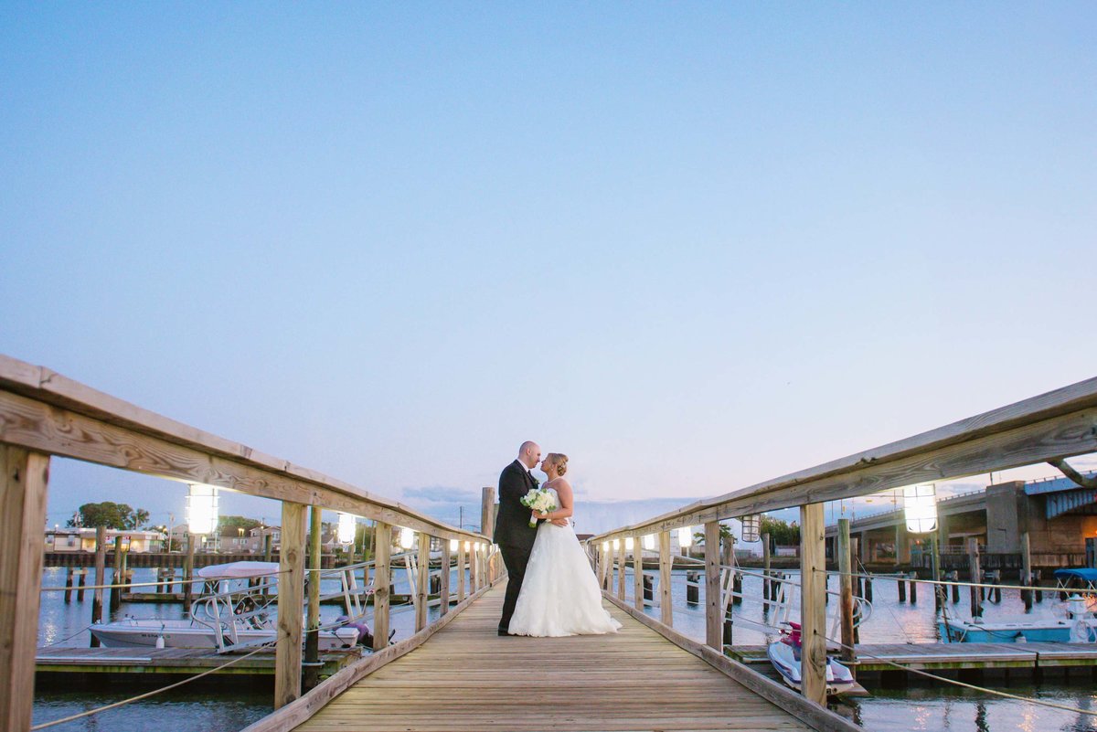 Bride and groom on the dock of Bridgeview Yacht Club