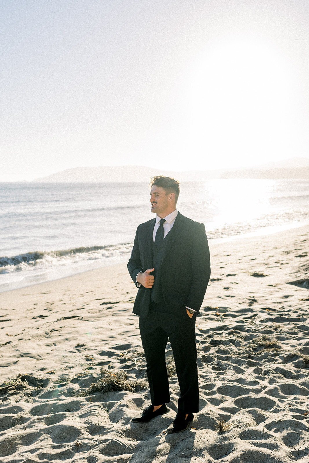 Groom on the beach at Dolphin Bay Resort in Pismo Beach, CA