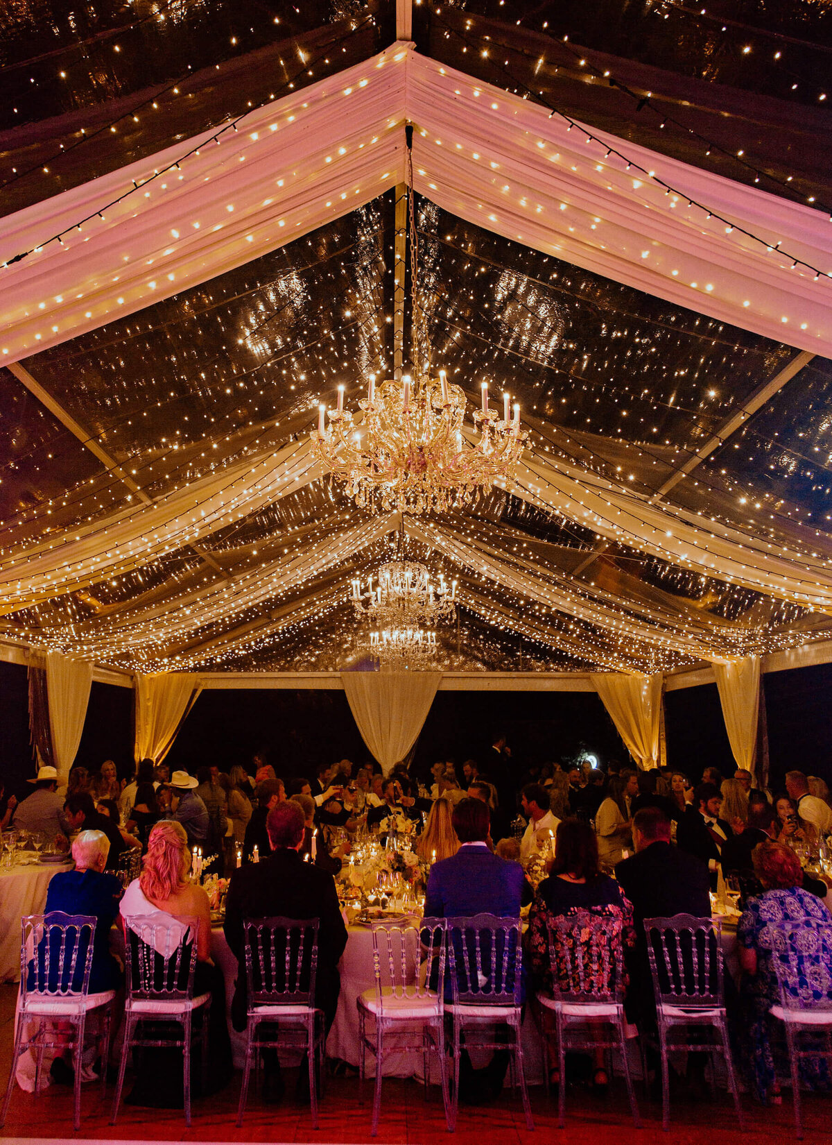Wedding dinner under clear top tent at castle in Frane