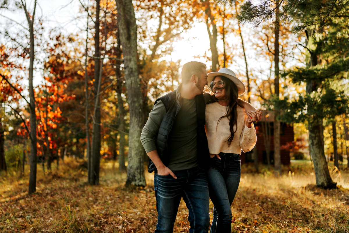 couple laughing and walking in autumn season