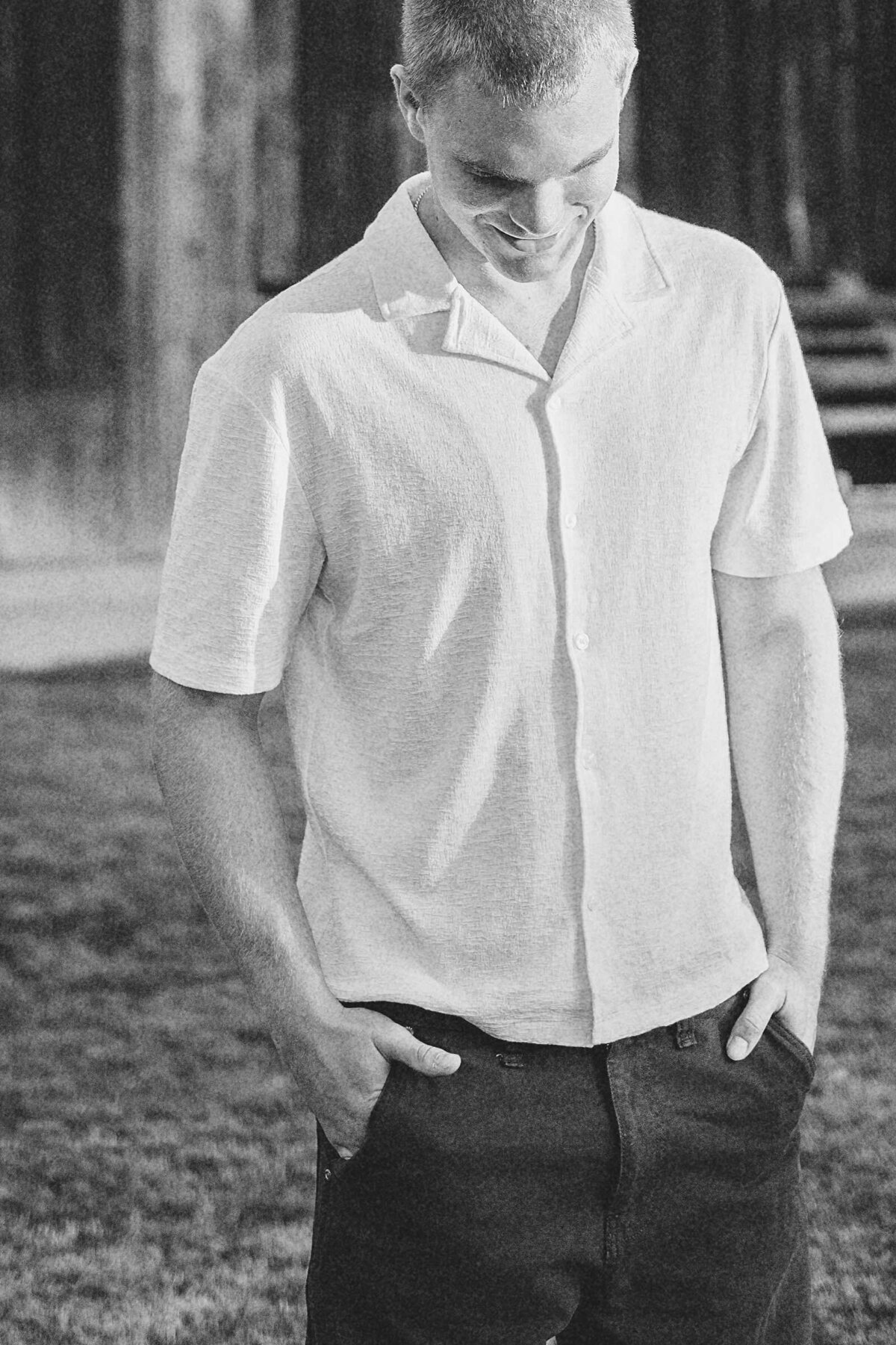 Senior guy picture ideas: cropped in black and white photo of a male with his hands in his pockets