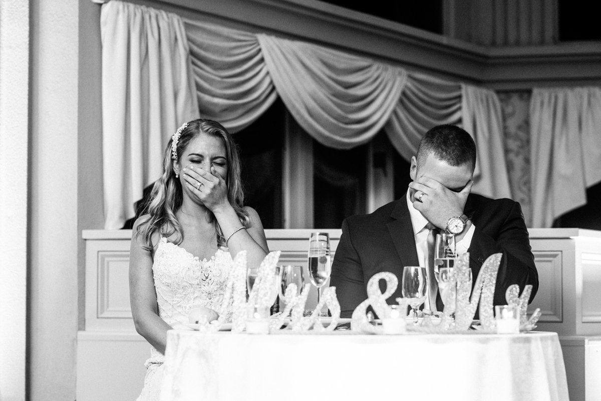 Couple laughing during wedding toasts