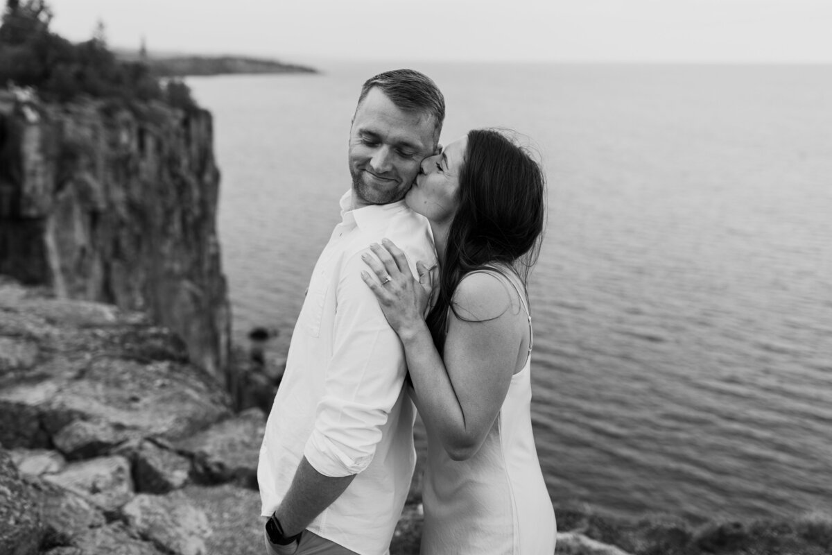 A couple takes engagement photos at Palisade Head in Silver Bay, Minnesota. Photo taken by Minnesota Wedding Photographer, Morgan Elizabeth Photography www.morganelizabethphoto.com @morganelizabethphotos