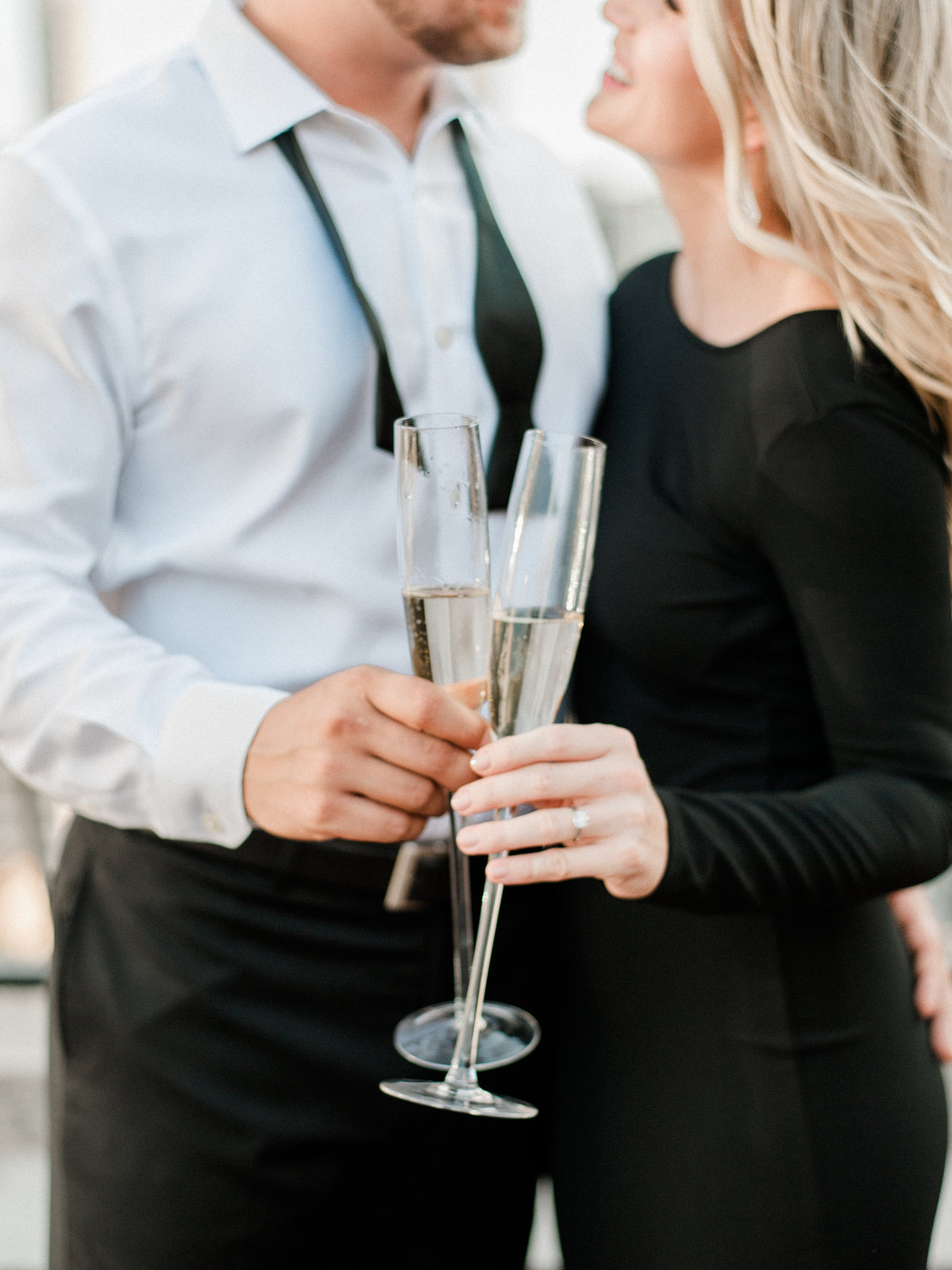 engaged couple holding champagne flutes