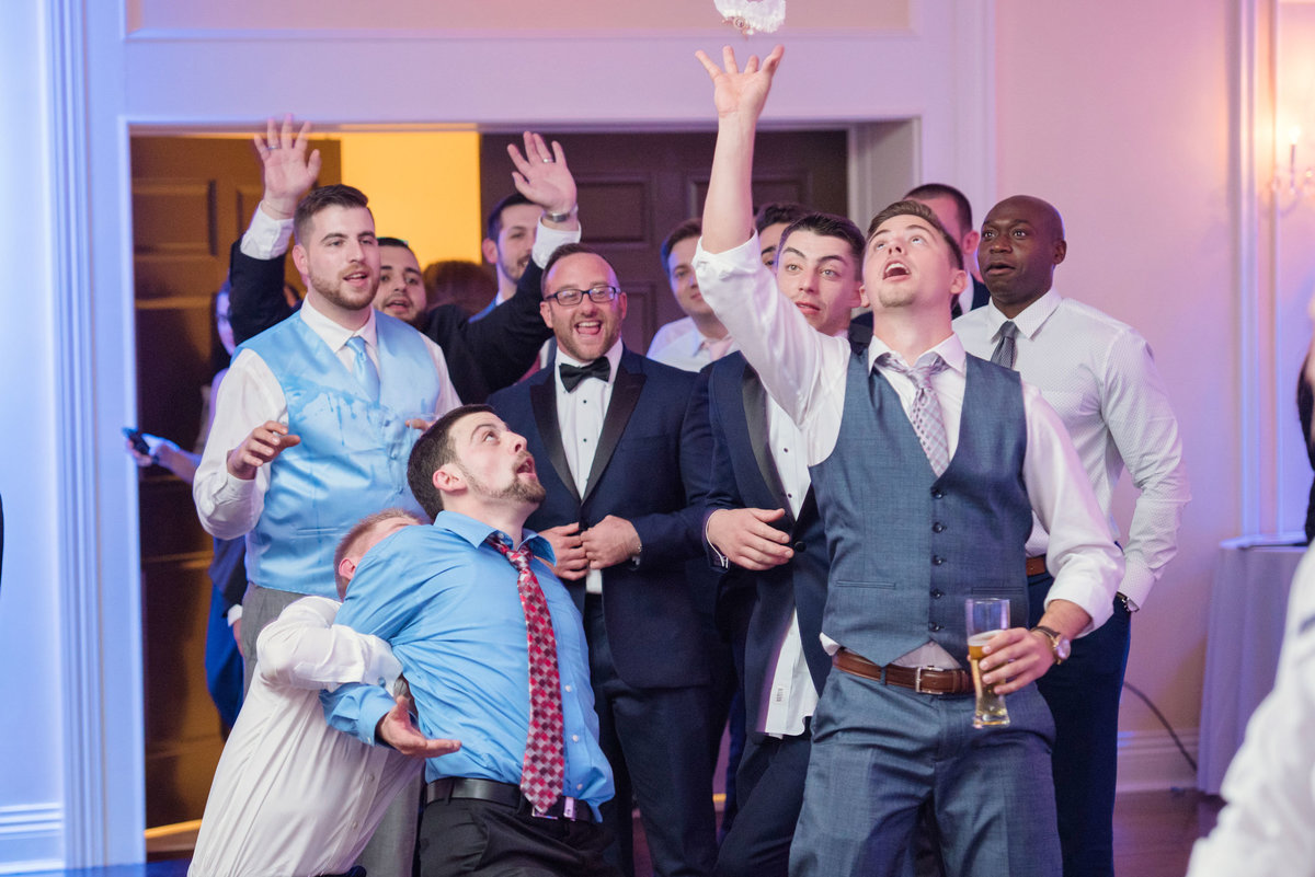 Groomsmen catching the garter at Soundview Caterers