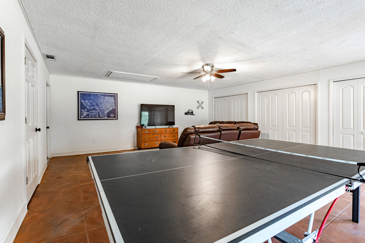 Spacious living room with ping pong table and TV at this three-bedroom, two-bathroom ranch house for 7 with incredible hiking, wildlife and views.