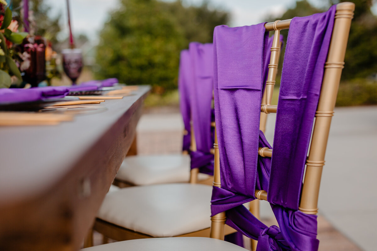 alt="custom purple ties on chair"
