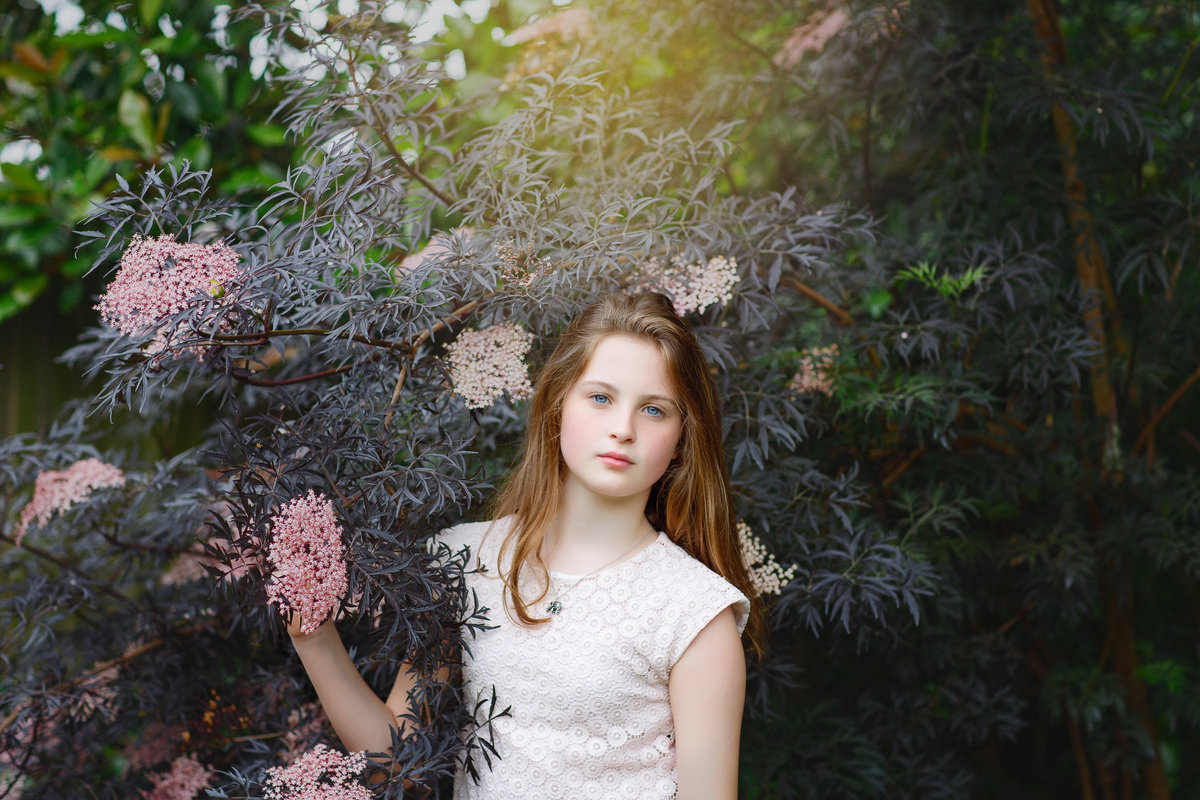 young girl standing in garden