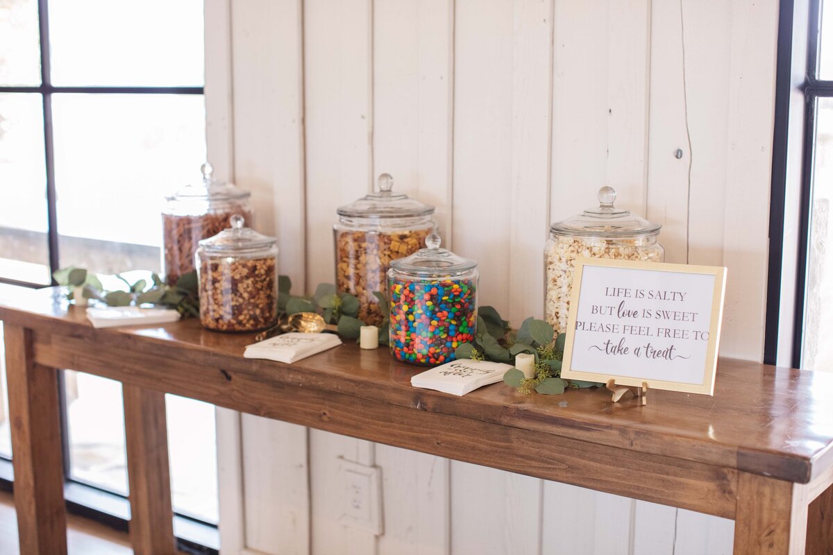 something sweet and salty in jars on wooden table at wedding reception Milestone New Braunfels Texas
