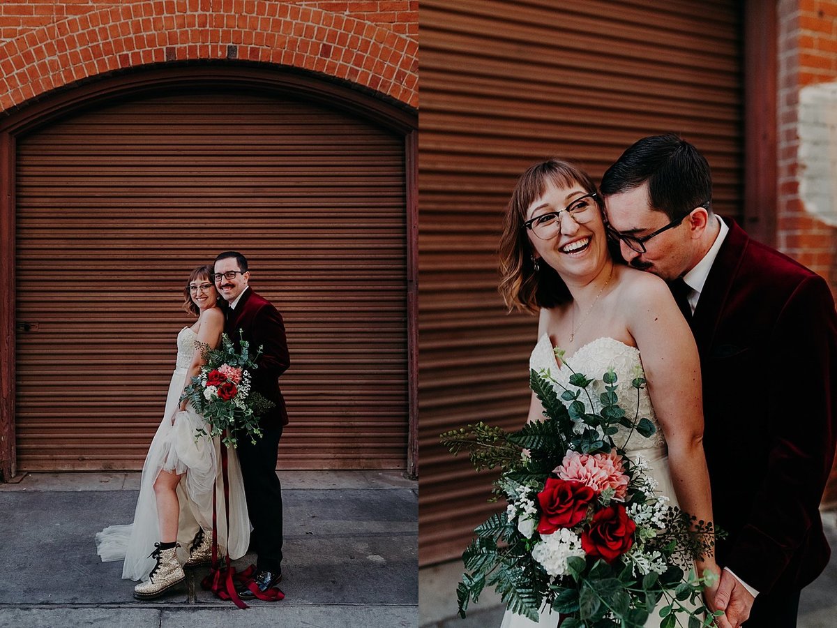 Groom stands behind bride while she holds the bouquet and he kisses her neck